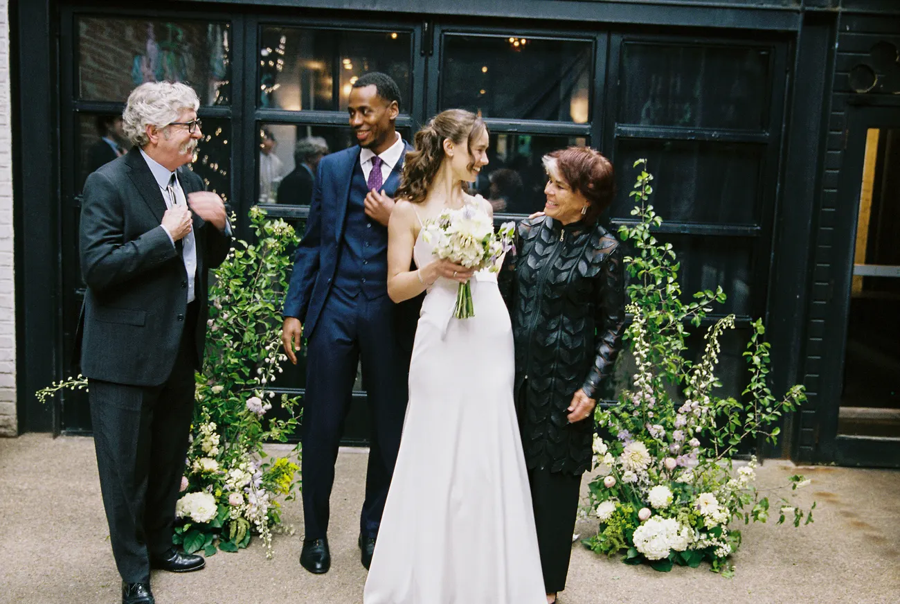 Wedding meadow installations of dahlias and greenery flanking black doors at Maketto