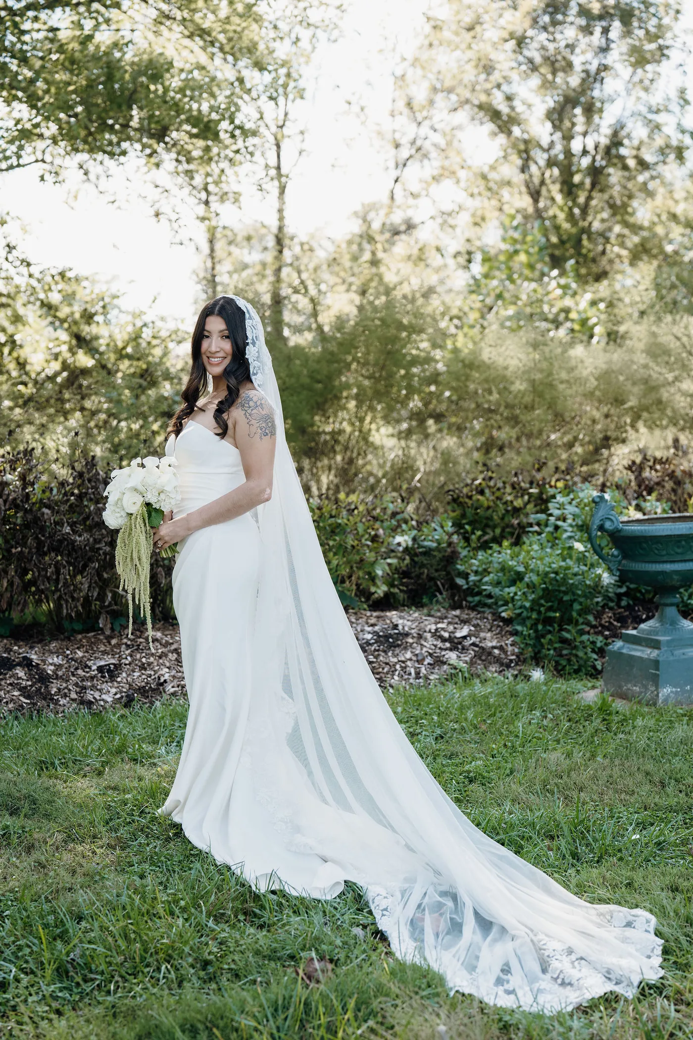 Bride holding a white calla lily bouquet with trailing amaranthus