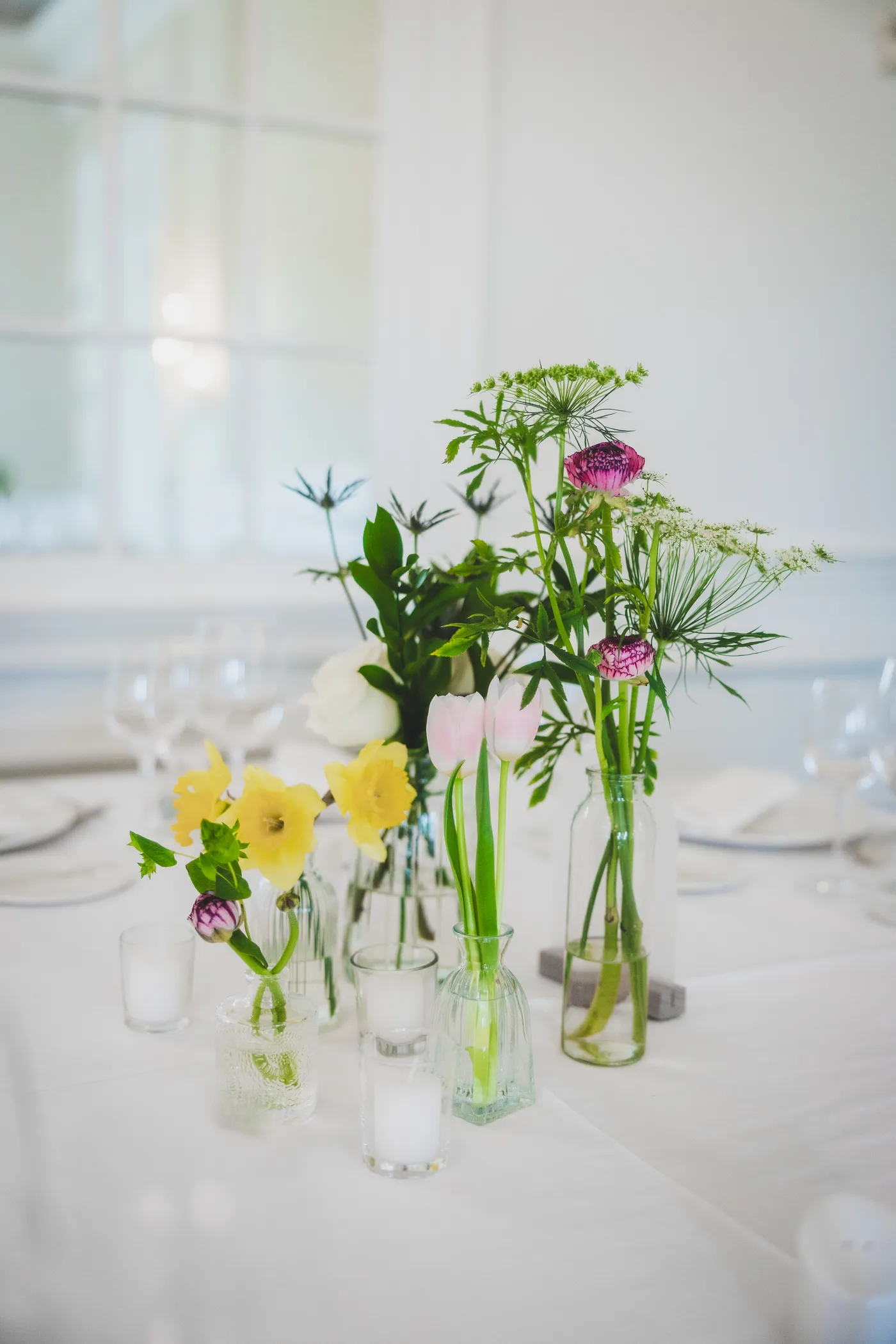Tulips and spring flowers in glass bud vases at a Virginia wedding reception