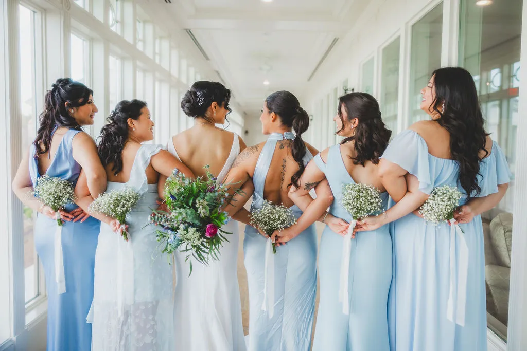 Bridesmaids in blue holding spring bouquets at Washington Golf & Country Club