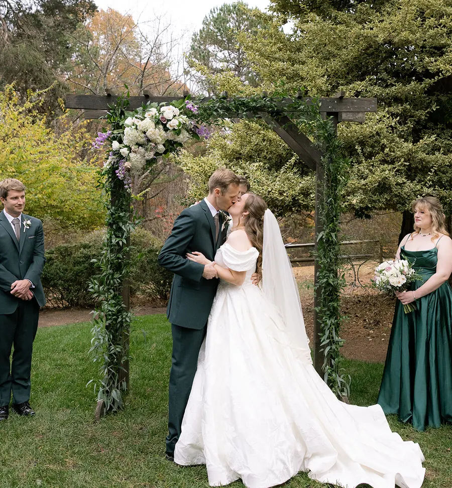 A pergola dressed in roses & trailing greenery