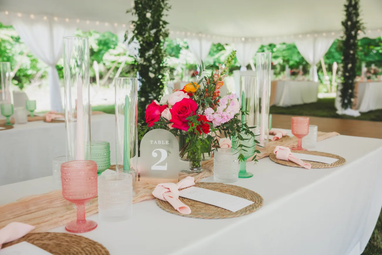 A tented reception in coral, blush & green